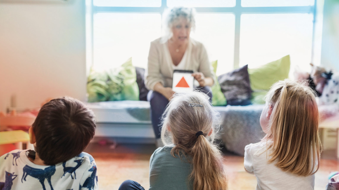 Woman explains chart to children