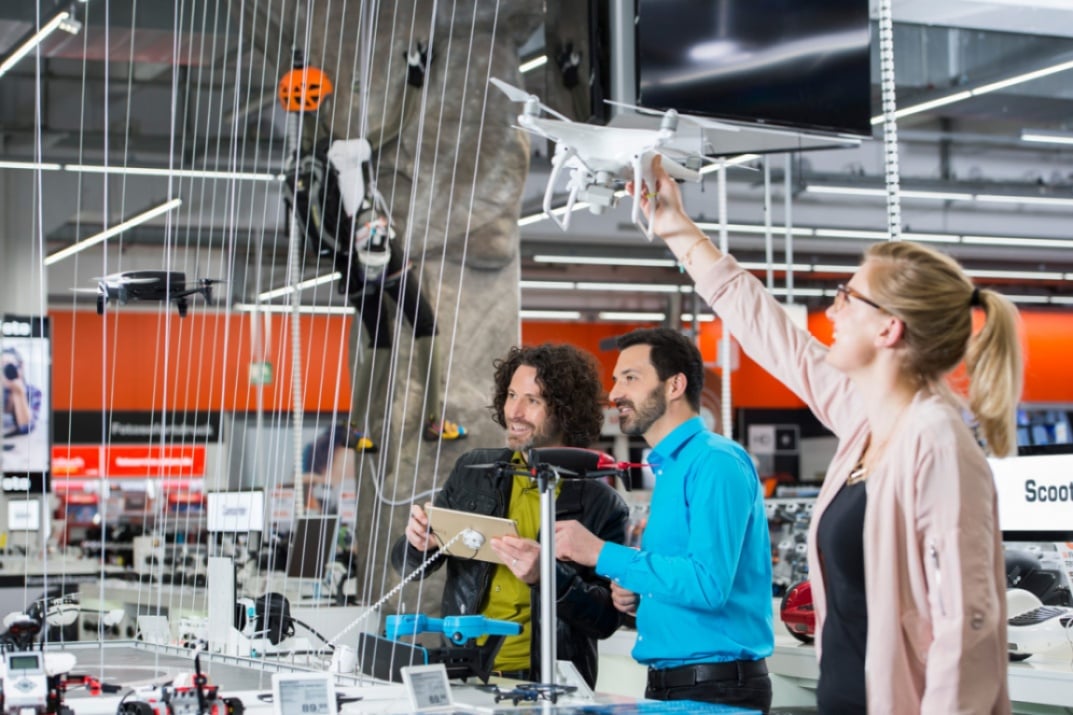 Customer playing with drone in Saturn store